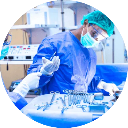 nurse handing medical equipment to surgeon during an operation