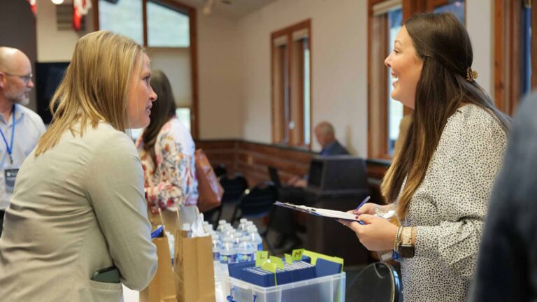 Guests are greeted with a warm welcome at the registration table