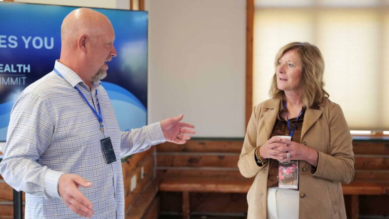 Dr. Scheer and Carrie Lutz engage in meaningful conversation before the Summit begins.