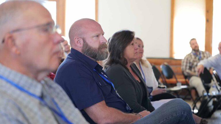 Attendees engaged and focused during a Summit session.