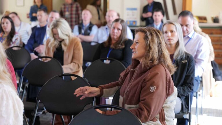 Manny Banner and fellow attendees focus intently during a Summit session.