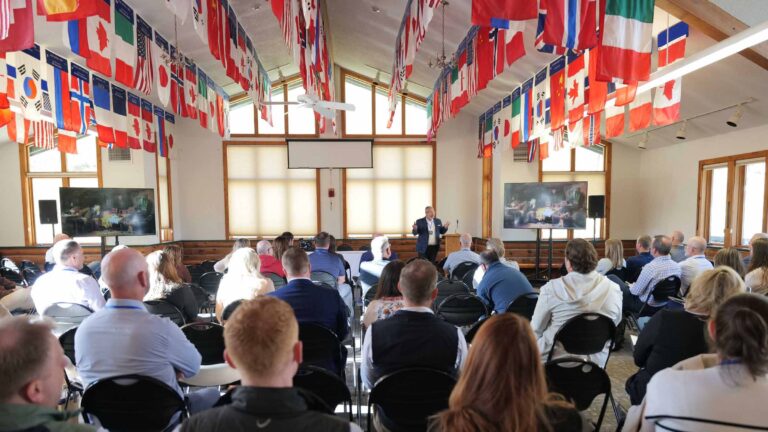 Attendees listen as Jeffrey Daigrepont, SVP of Coker, presents at the 2025 Summit in Olympian Hall.