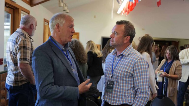 Andrew Weides and Kurt Loveless connect during a break between Summit sessions.
