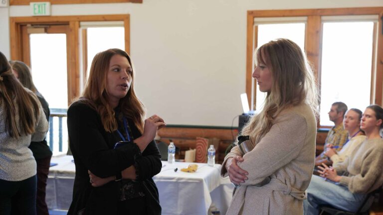 Tess Riherd connects with an attendee during a break between Summit sessions
