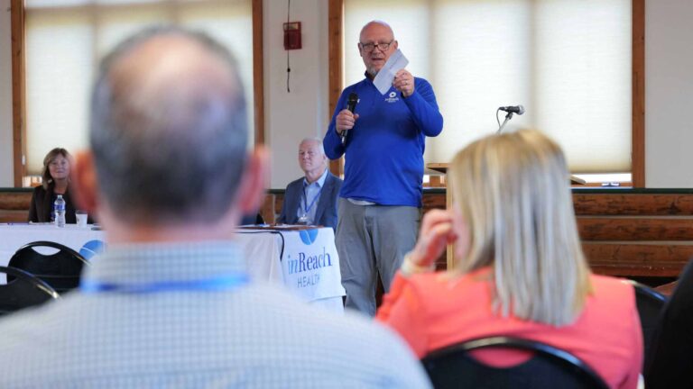 Bryan Scheer draws connections between his mountain climbing experiences and rural healthcare challenges at the 2025 Summit.